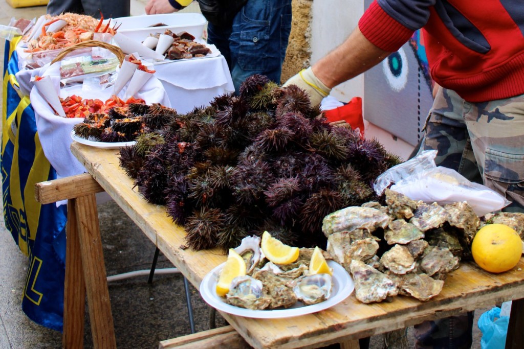 Sea urchin, oysters and other seafood on a wooden table 