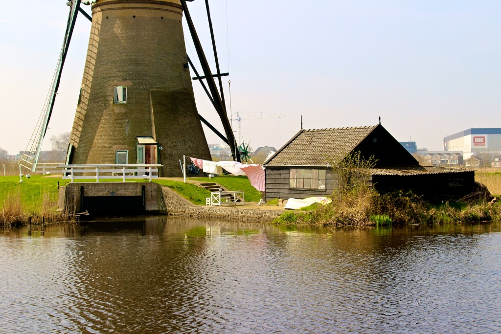 The base of one of the many windmills at Kinderdijk, Netherlands. There is a clothing line outside. 