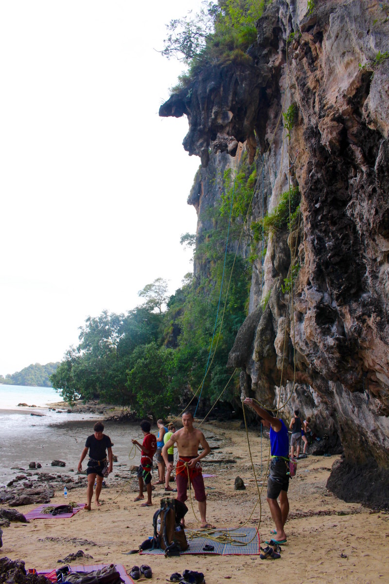 Skilled rock climbers at the base of the wall at Railay Beach, Thailand