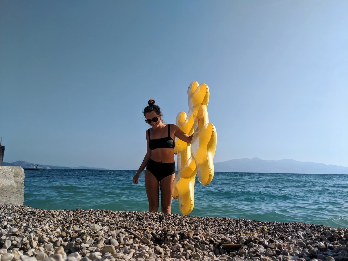 Me getting out of the sea with our hashtag pool float in hand in Kodrra Saranda Albania