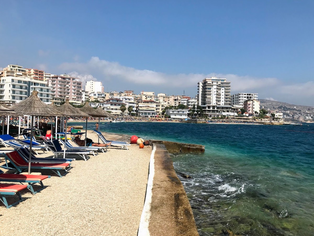 A view of the beach with the tall buildings in the background, mostly hotels in Kodrra, Saranda, Albania