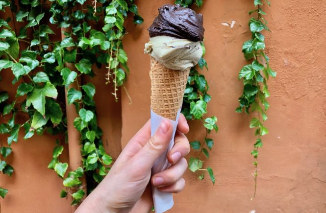 A cone of pistachio and chocolate gelato