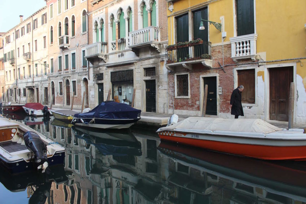 A man walking by the canal in Venice on a quiet morning in Venice