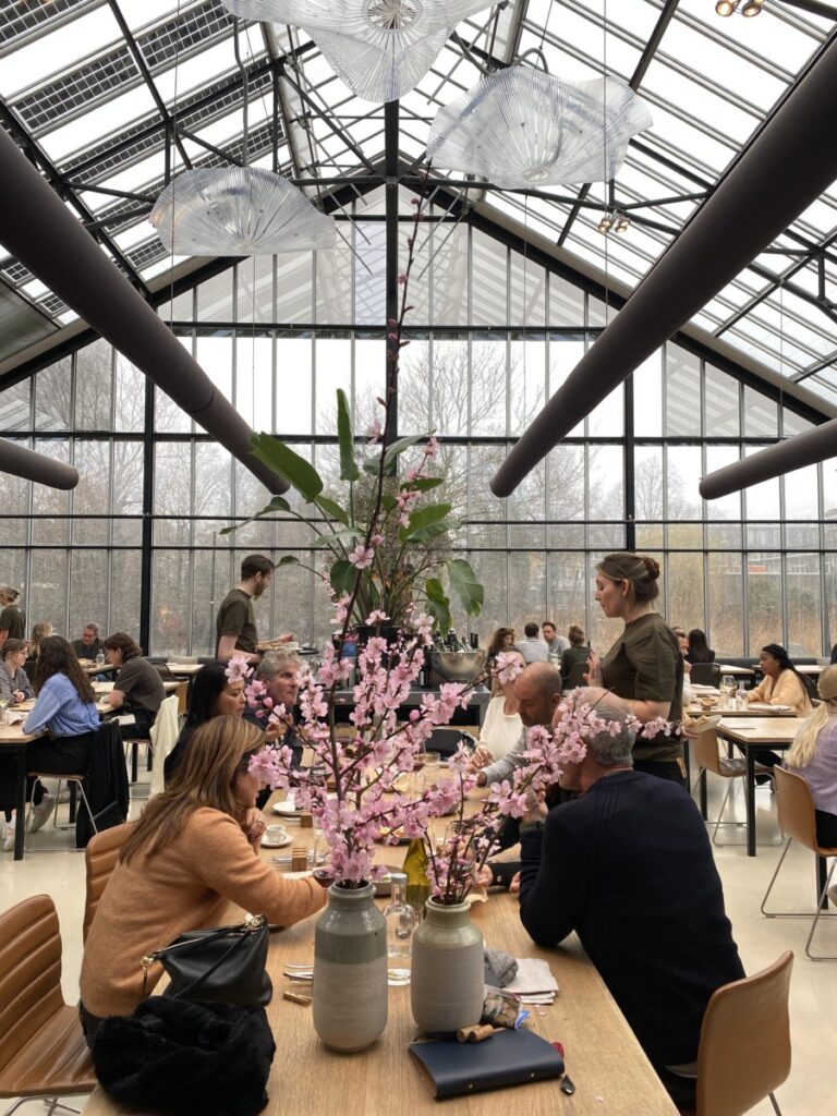 The ambience at Restaurant De Kas, a table with orchids in the greenhouse