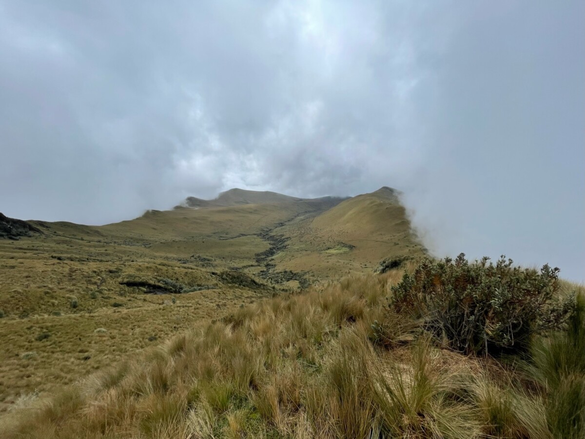 In the distance you can see the fog coming over the ridge of the cliff, with the summit beyond it