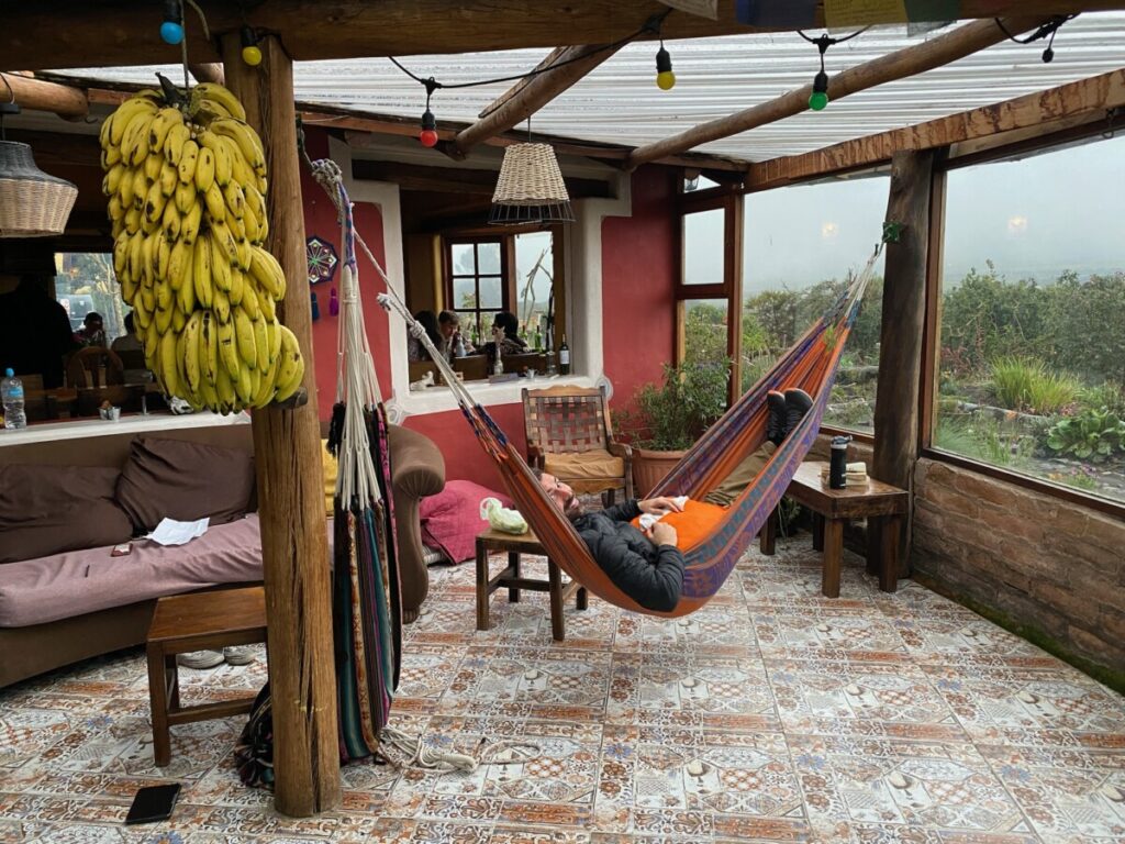 The common space at Secret Garden Cotopaxi, Mike is hanging on a hammock