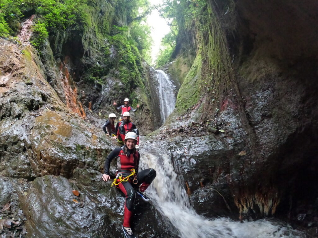 The whole group waiting at the top of the waterfall before canyoning in Banos