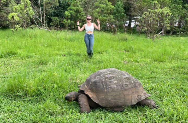 Me standing with a giant tortoise at El Chato