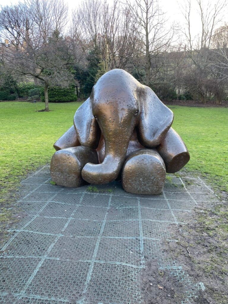 A baby elephant statue in the park