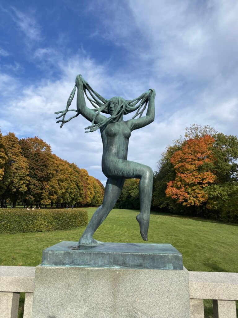 A statue of a woman pulling her hair