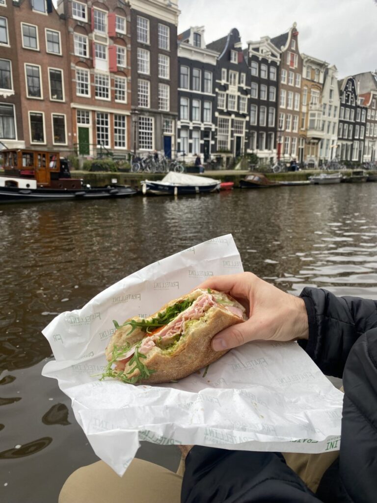 The Prosciutto Cotto sandwich held over the canal