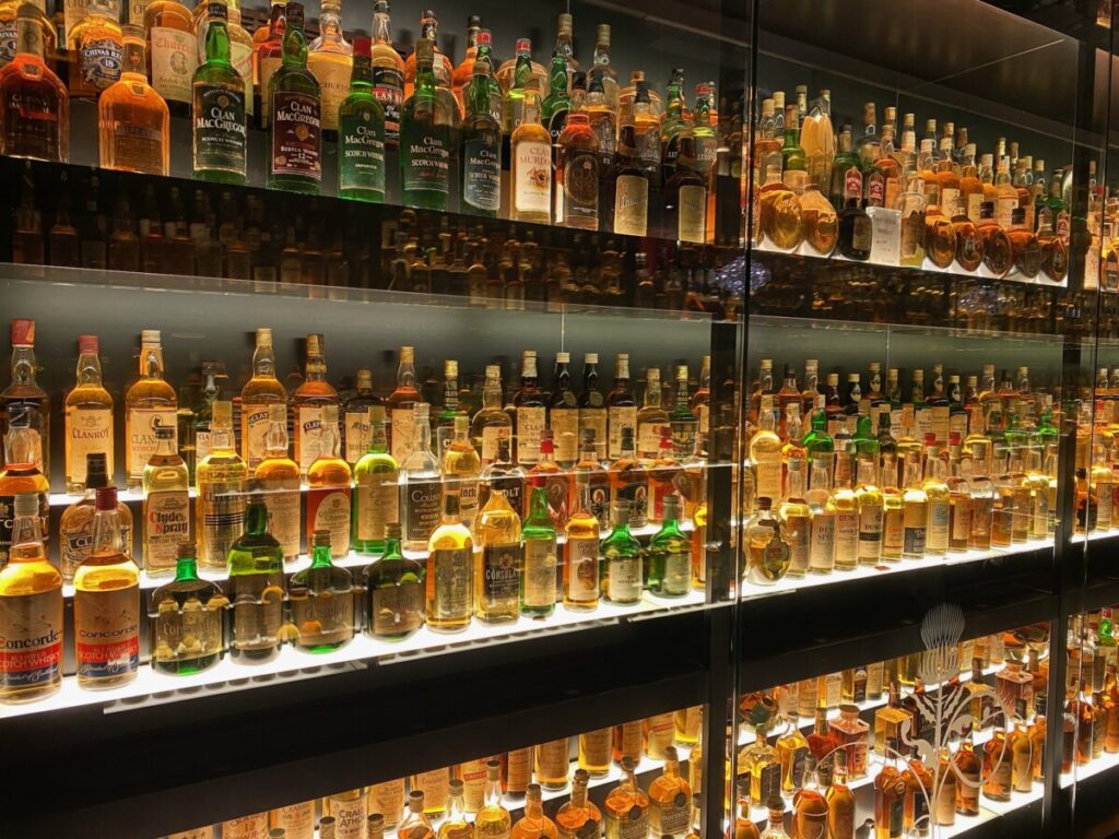 The whisky bottles of the largest whisky collection in the world behind glass wall