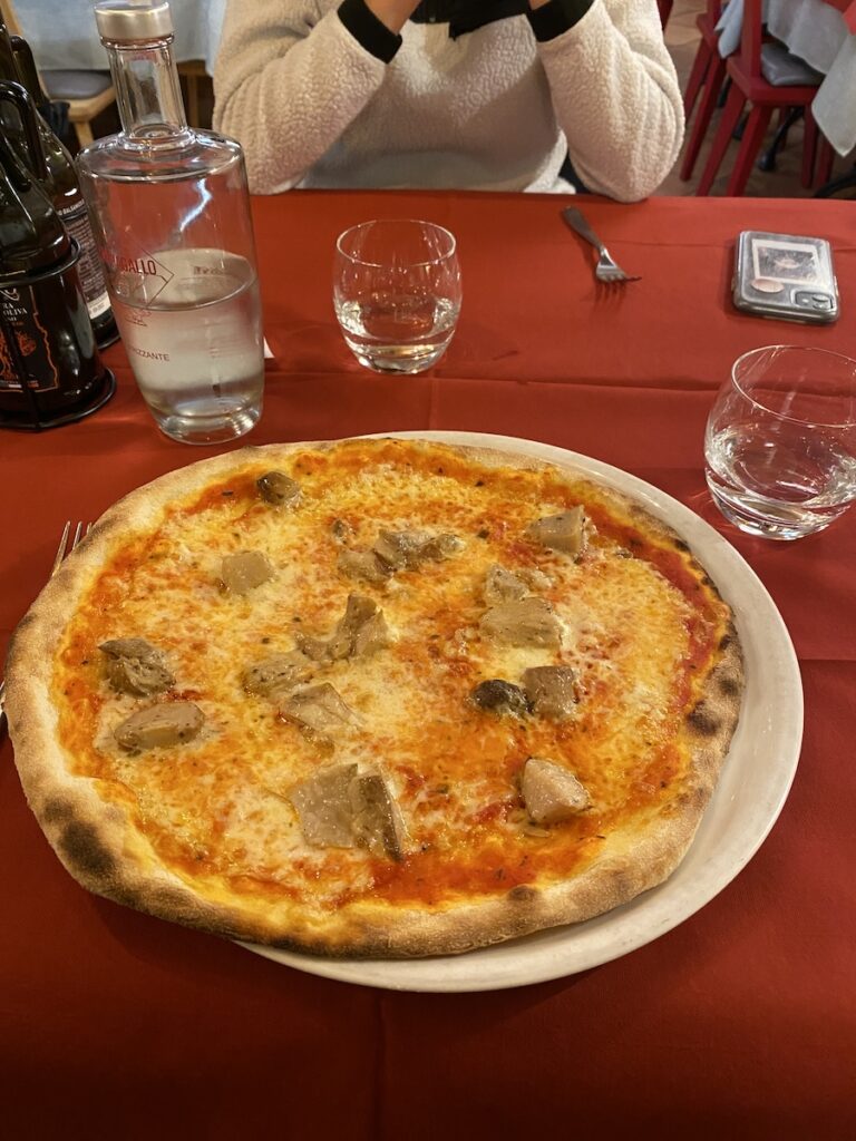 Pizza with mushrooms on a red table cloth