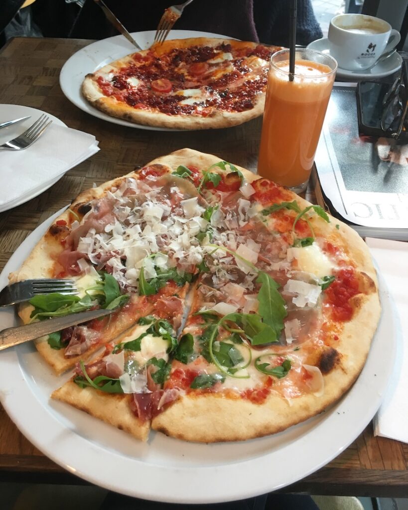 La Perla, a prosciutto pizza and a spicy pizza. One of the best restaurants and bars in Jordaan