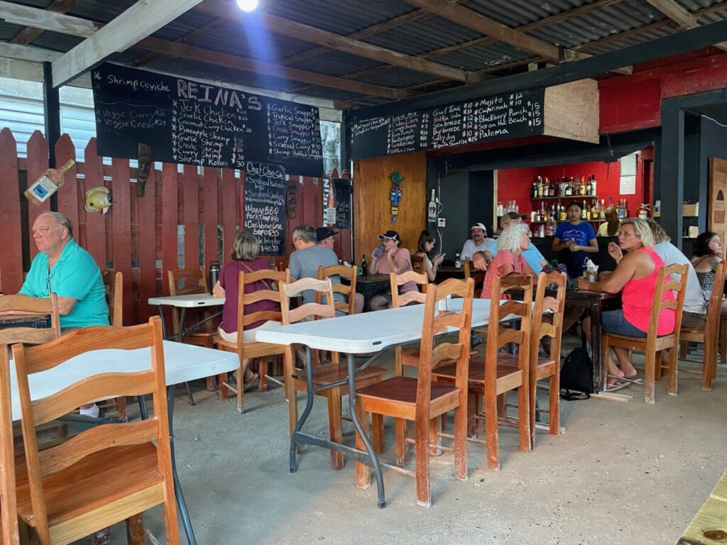 Reina's restaurant on Caye Caulker at opening time. Many empty seats