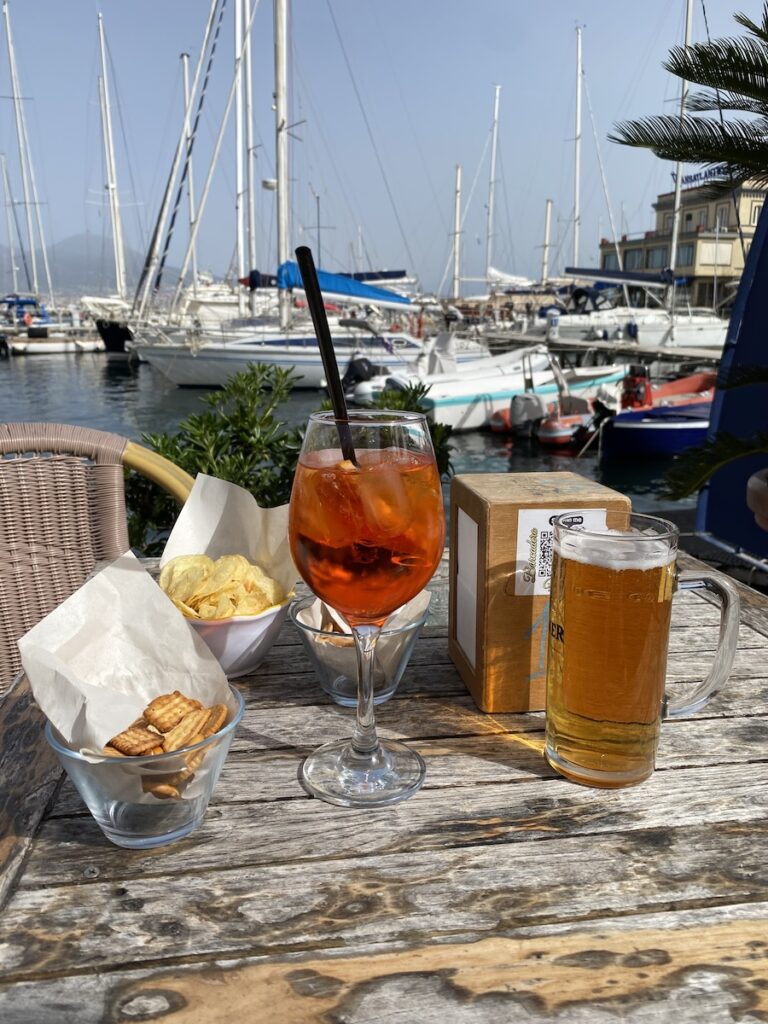 Aperol spritz and a beer, with snacks 