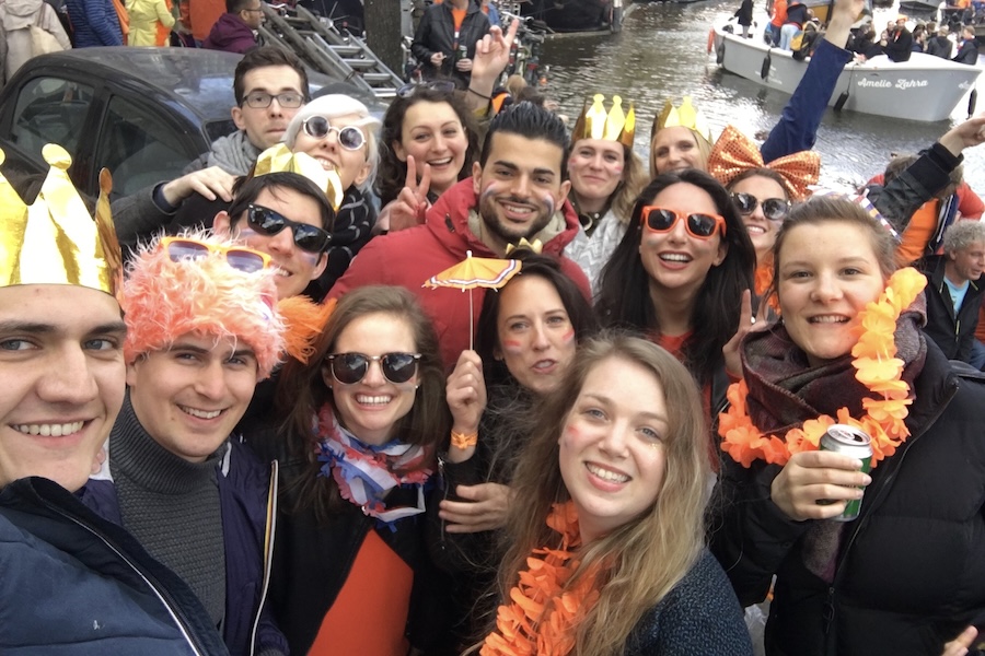 A group of people on the street on King's Day in Amsterdam