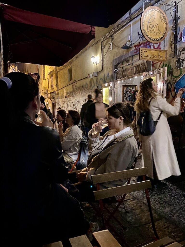 A view of a busy street with a bar in Naples, Italy
