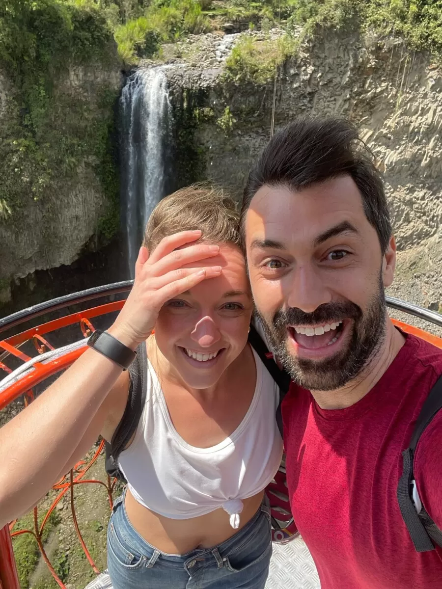 Mike and Jade on the cable car in Baños crossing the river in the wind
